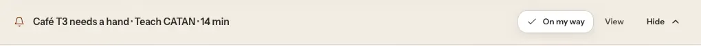 The top of an admin page. Under the top bar, a banner reads Café T3 needs a hand, Teach CATAN, 14 min, with On my way, View and Hide buttons.