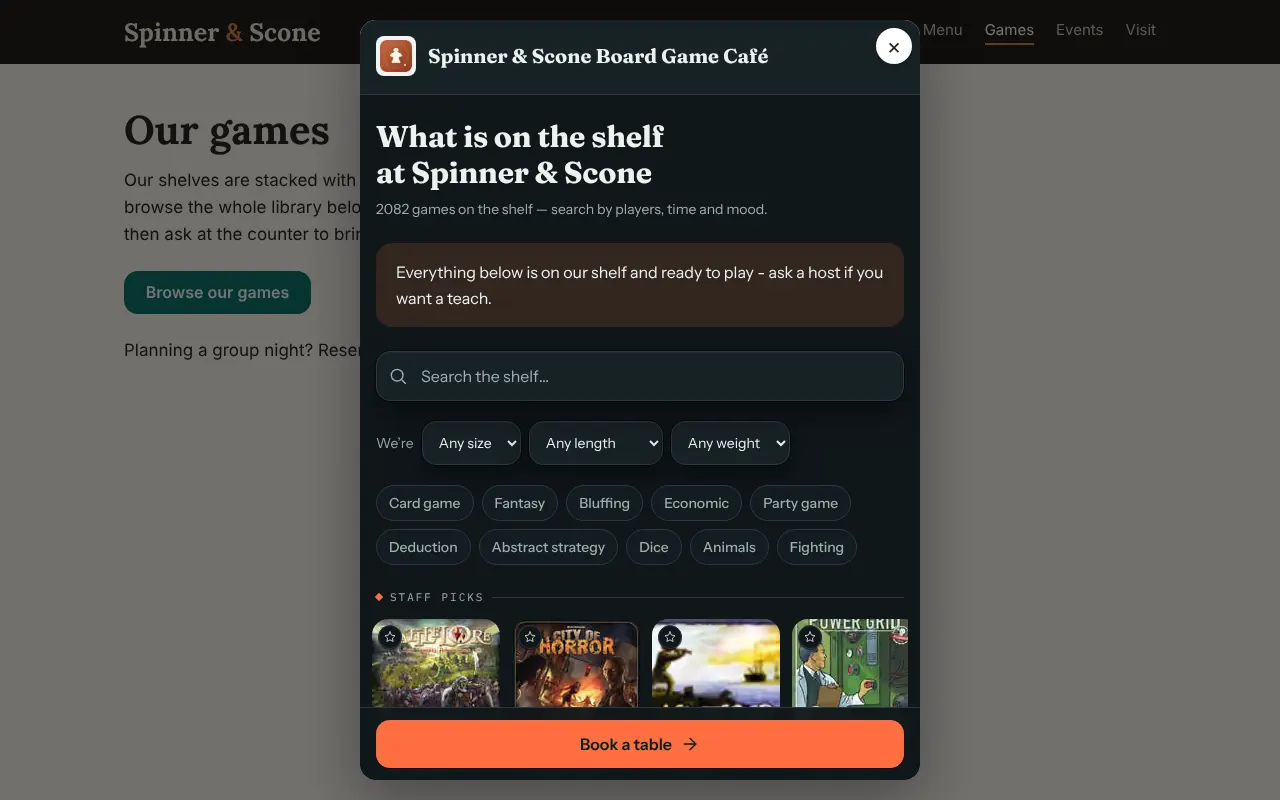 A café's Our games page dimmed behind a window. The window shows the café's name with a close button, the heading What is on the shelf at Spinner & Scone, a search box, filters, and a Book a table button at the bottom.