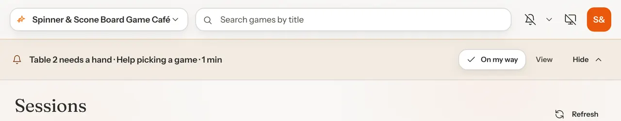 The banner at the top of an admin page reading Table 2 needs a hand, Help picking a game, 1 min, with On my way, View and Hide buttons.