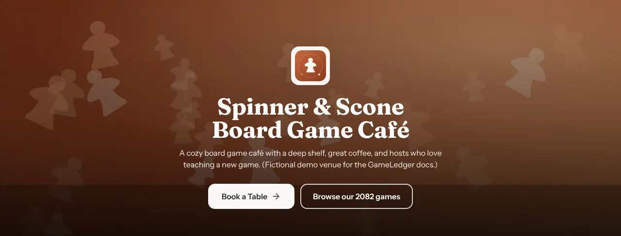 The top of the Spinner & Scone venue page: a cover photo of meeples behind the café's logo tile, its name, a one-line description, a white Book a Table button and an outlined Browse our 2082 games button.